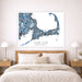 Map of Cape Cod Massachusetts on a wall above a bed with nightstands and lamps.