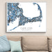 Framed map of Cape Cod, Massachusetts on a wall above a beige sofa with light blue pillows.