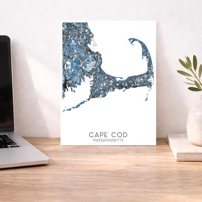 Cape Cod Massachusetts map print on a desk with a laptop and plant.