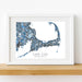 Framed map of Cape Cod, Massachusetts on a white wall.