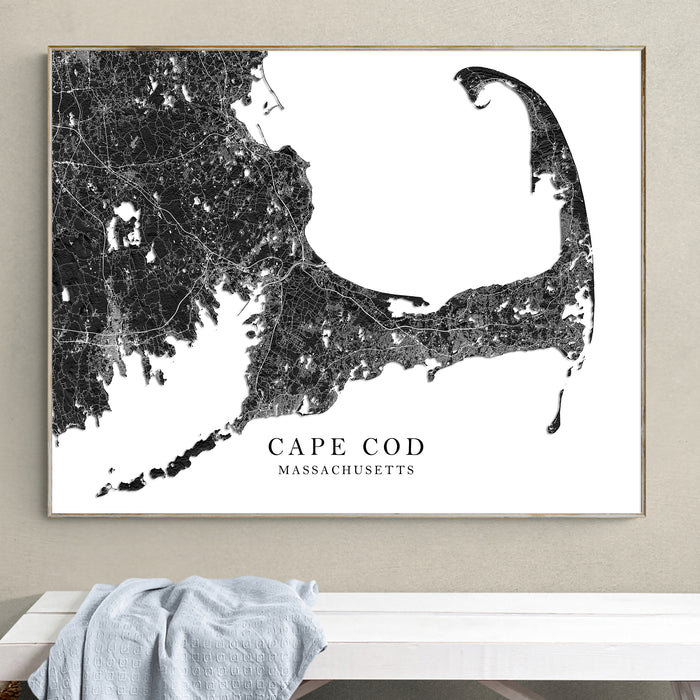 Framed map of Cape Cod, Massachusetts on a wall above a white surface.