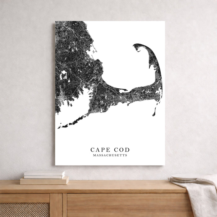 Cape Cod Massachusetts map art print on a wall above a wooden surface.
