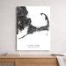 Cape Cod Massachusetts map art print on a wall above a wooden surface.