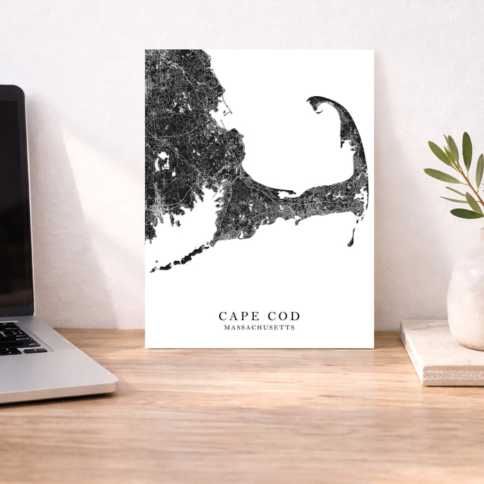 Cape Cod Massachusetts map print on a desk with a laptop and plant.