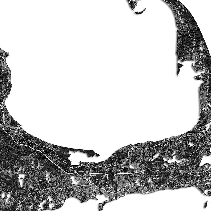 Black and white map of a coastal region with roads and water bodies.