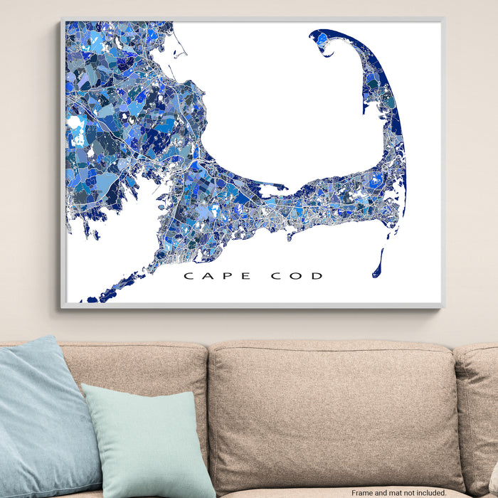 Map of Cape Cod with blue mosaic pattern on a white background, displayed above a beige sofa.