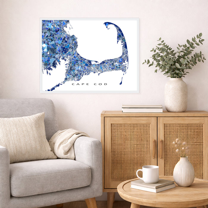 Living room with a map of Cape Cod on the wall, a couch, and a side table with decor items.