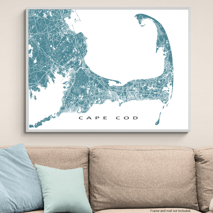 Map of Cape Cod on a wall above a beige sofa with light blue pillows.