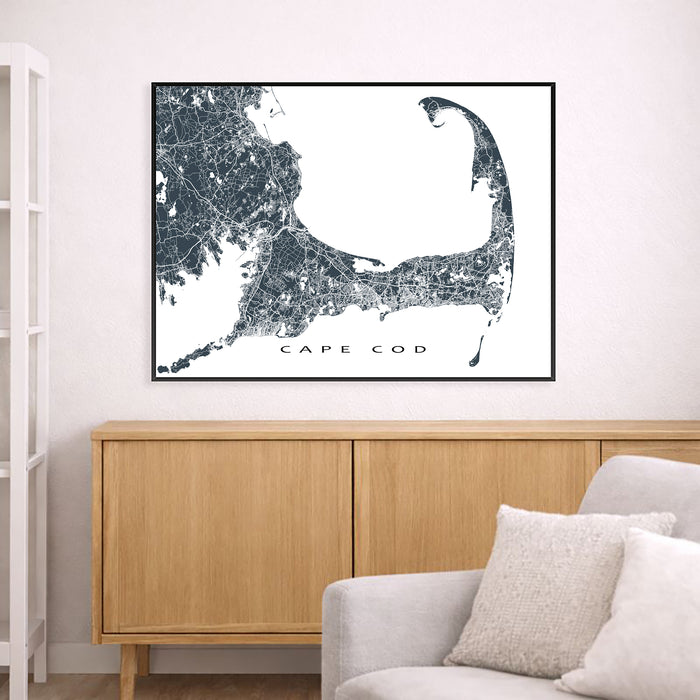 Framed map of Cape Cod above a wooden cabinet in a living room.