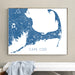 Framed map of Cape Cod on a wall above a white bench.