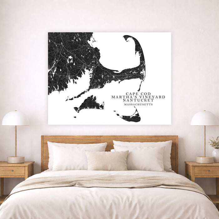 Map of Cape Cod, Martha's Vineyard, and Nantucket on a wall above a bed.