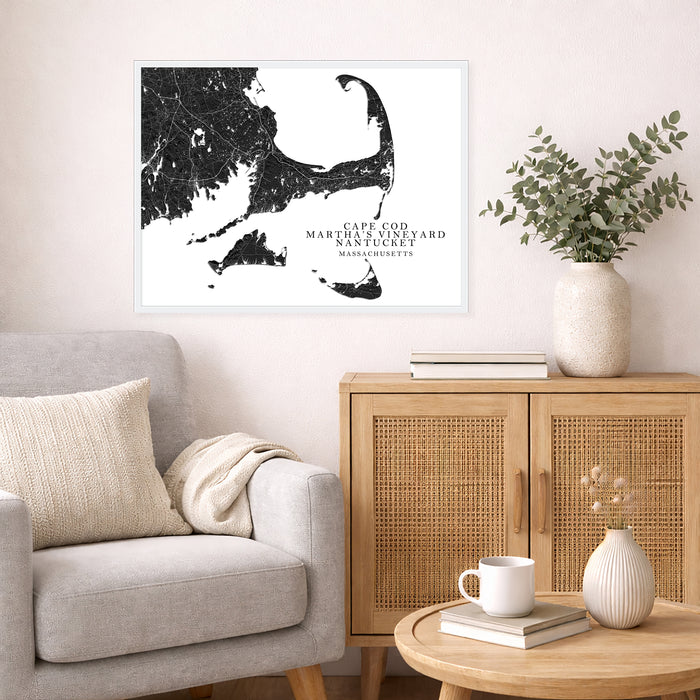 Living room with a map of Cape Cod on the wall, a couch, and a side table with decor items.