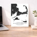 Map of Cape Cod, Martha's Vineyard, and Nantucket on a white background next to a laptop on a wooden desk.