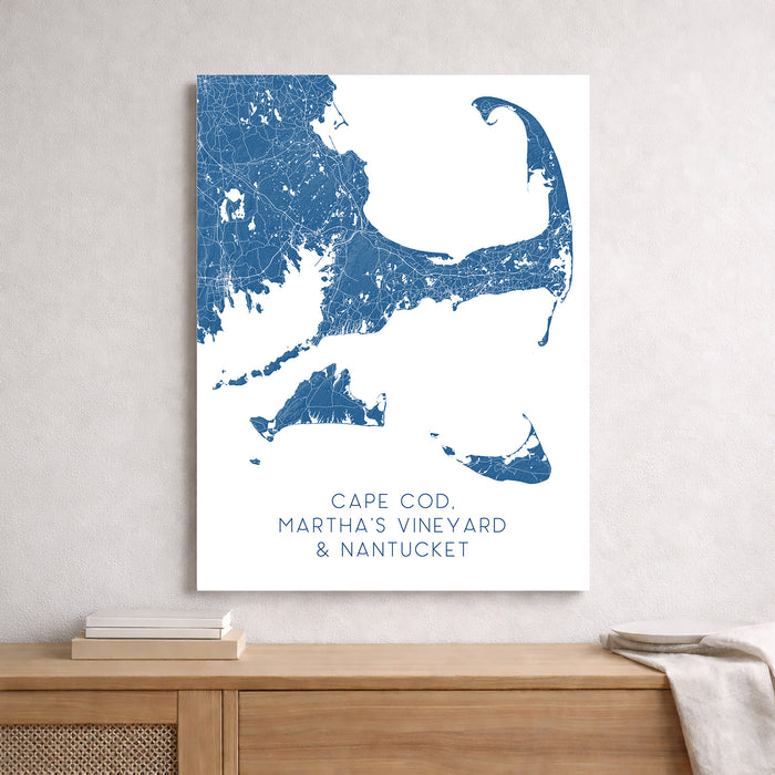 Map of Cape Cod, Martha's Vineyard, and Nantucket on a white wall above a wooden surface.