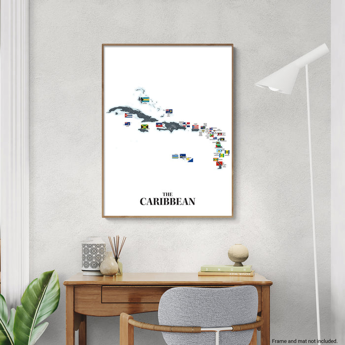 Framed map of the Caribbean with country flags on a wall above a desk.