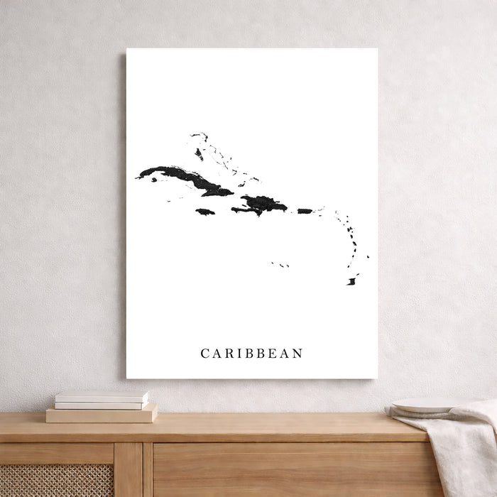 Framed map of the Caribbean on a wall above a wooden console table.