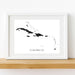 Framed black and white map of the Caribbean on a wooden shelf.