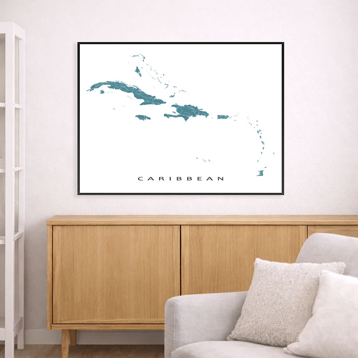 Framed map of the Caribbean on a wall above a wooden cabinet and sofa.