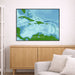 Framed map of the Caribbean on a wall above a wooden cabinet and sofa.