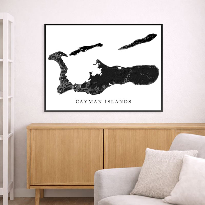 Framed map of Cayman Islands on a wall above a wooden cabinet and sofa.