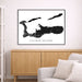 Framed map of Cayman Islands on a wall above a wooden cabinet and sofa.