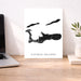 Map of Cayman Islands on a desk with a laptop and plant