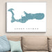 Framed map of Grand Cayman on a wall above a beige sofa with light blue pillows.