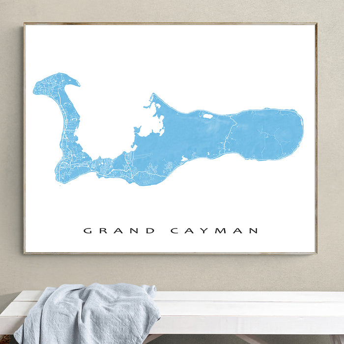 Framed map of Grand Cayman on a wall above a bench.