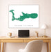 Framed map of Grand Cayman on a wall above a desk with a laptop and lamp.