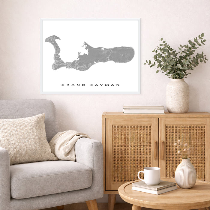 Living room with a map of Grand Cayman on the wall, a couch, and a wooden cabinet.