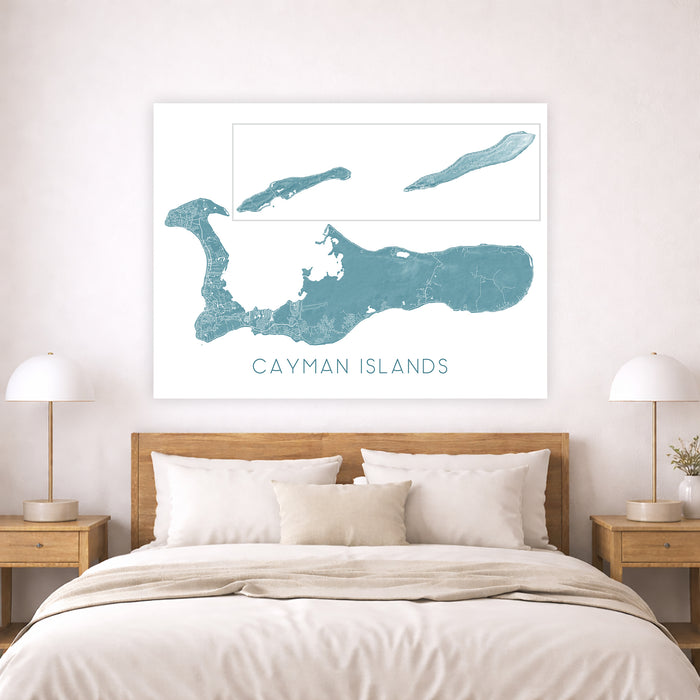 Framed map of the Cayman Islands above a bed in a bedroom setting.
