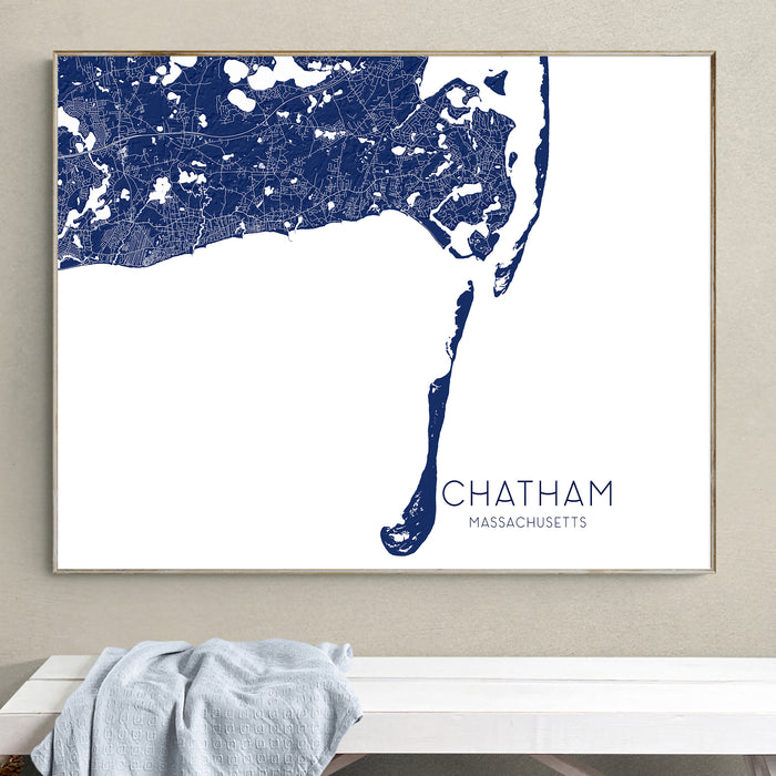 Framed map of Chatham, Massachusetts on a wall above a white bench.