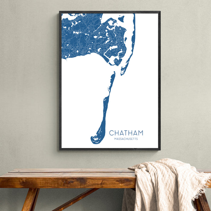 Framed map of Chatham, Massachusetts on a wall above a wooden bench.