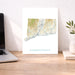 Map of Connecticut on a desk with a laptop and plant