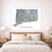 Map of Connecticut on a wall above a bed in a bedroom setting
