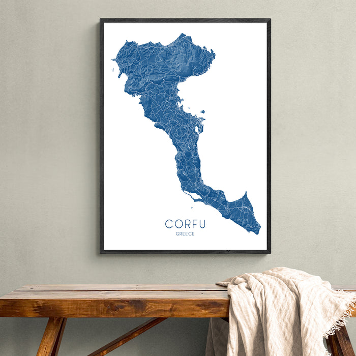 Framed map of Corfu on a wall above a wooden bench.
