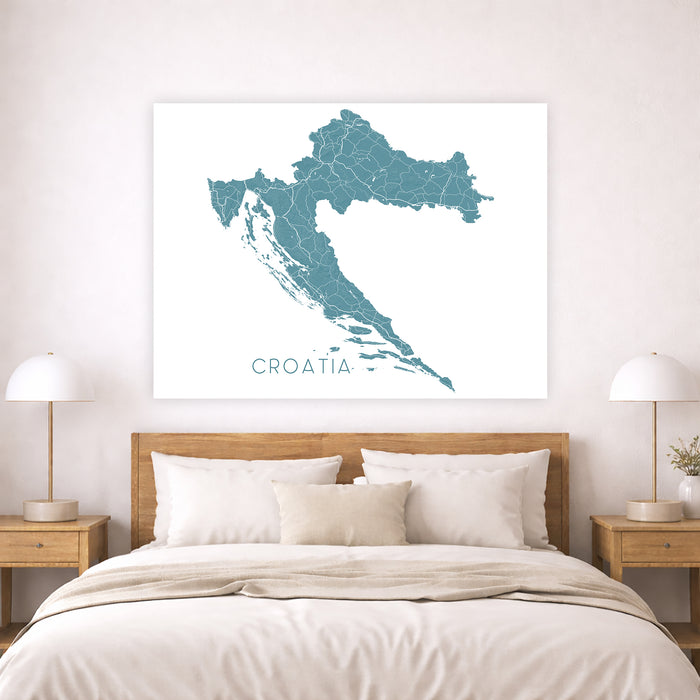 Map of Croatia on a wall above a bed in a bedroom