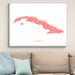 Framed map of Cuba on a wall above a beige sofa with light blue pillows.