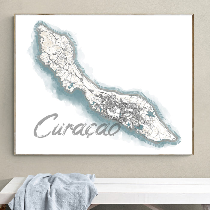 Framed map of Curaçao on a wall above a white surface with a light blue towel.