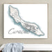 Framed map of Curaçao on a wall above a white surface with a light blue towel.