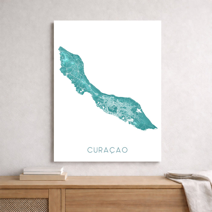 Framed map of Curaçao on a wall above a wooden shelf.