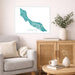 Living room with a map of Curacao on the wall, a vase with plants, and a coffee table with books and a mug.