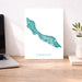 Map of Curacao on a desk with a laptop and plant