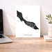Map of Curaçao on a desk with a laptop and plant