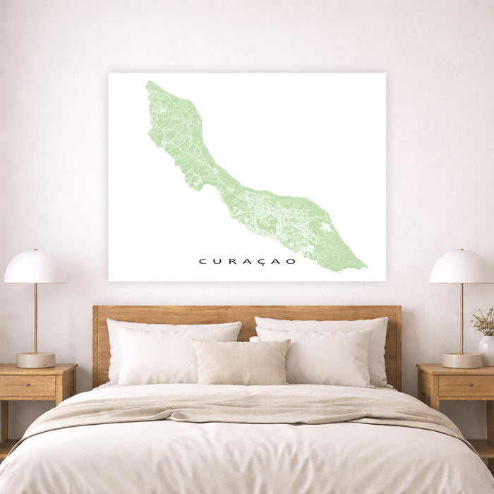 Map of Curacao on a wall above a bed in a bedroom setting