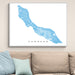 Framed map of Curaçao on a wall above a beige sofa with light blue pillows.