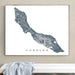 Framed map of Curaçao on a wall above a white surface.