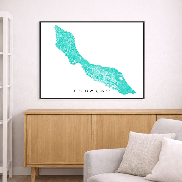 Framed map of Curacao on a wall above a wooden cabinet and sofa.