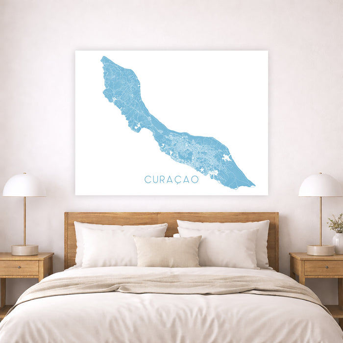 Map of Curacao on a wall above a bed in a bedroom setting