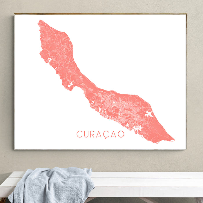 Framed map of Curaçao on a wall above a bench.